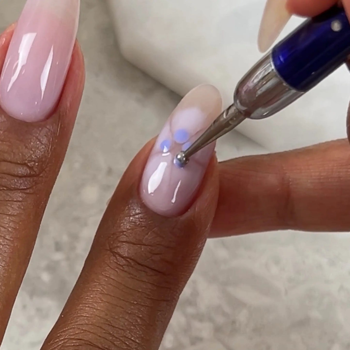Applying dot-tool "Bloom" nail art with DIVA #196 over DC #2471 "Lilac Clouds" base, pale lilac pink gel manicure