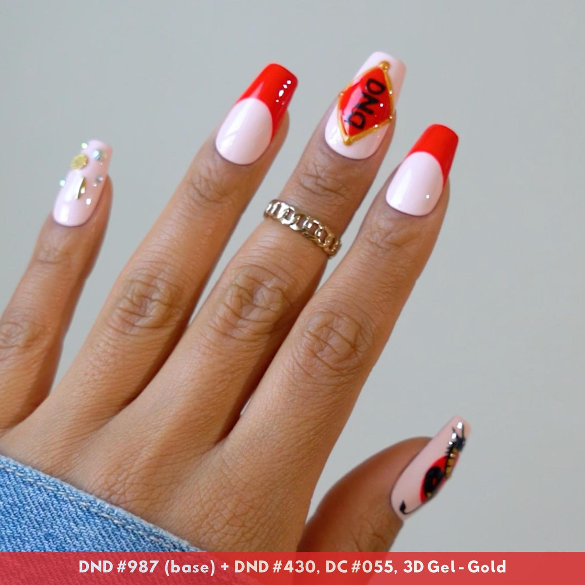 Hand with white and red nail art design, DND #430 and #987 nail art swatch