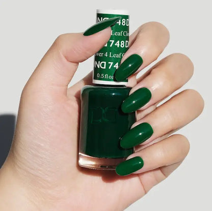 Rich green nail polish color on long rounded nails with glossy finish