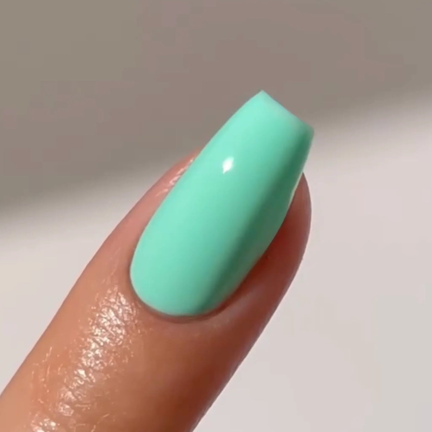 Close-up of a short coffin nail in bright mint green, DC #2536 Secret Paradise