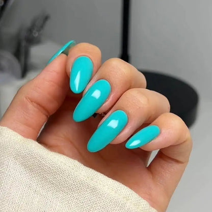 Hand with long oval nails and teal turquoise aqua tiffany blue nail polish