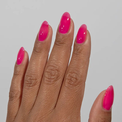 Close-up of fingers with glossy DC Jelly Hot Pink jelly gel nail polish manicure