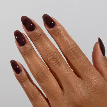 Hand with long almond nails wearing DC Jelly Cocoa muted soft brown jelly nail polish