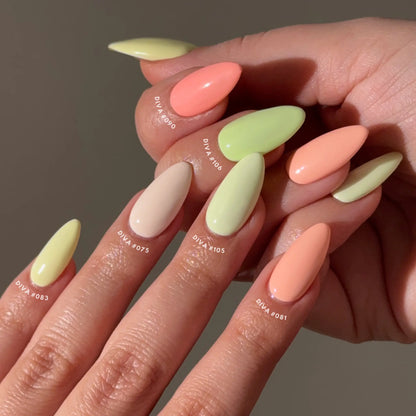 Close-up of hands with citrus pastel-colored nails on a neutral background