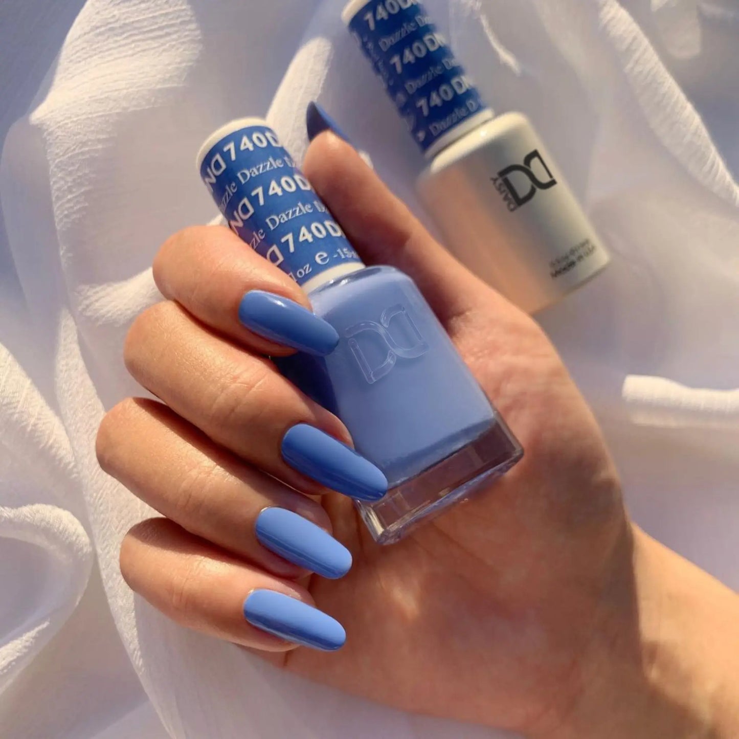 A powder soft periwinkle blue with vibrant undertones unique shade on long oval nails