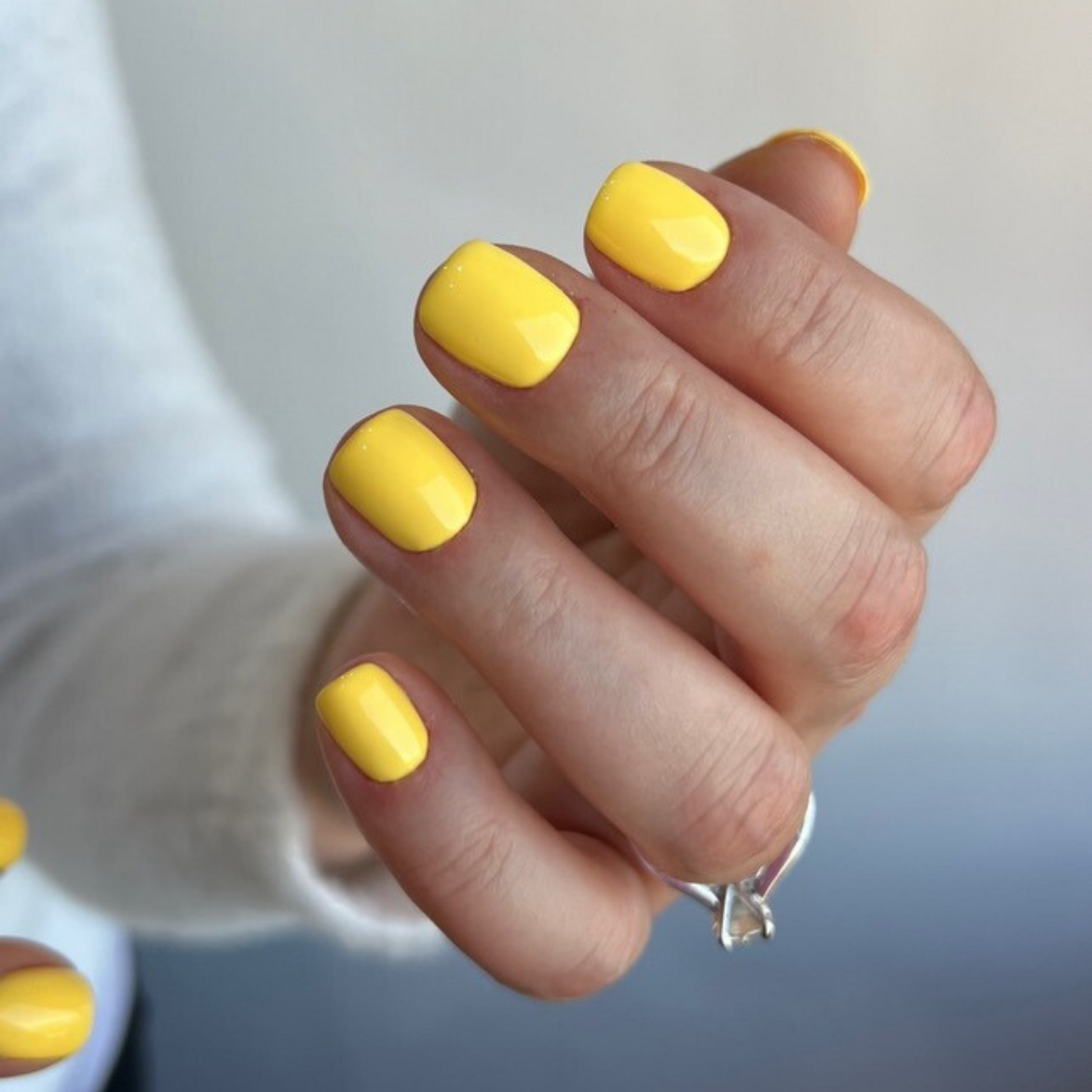 Honey-colored nail polish shade with glossy finish on natural square nails