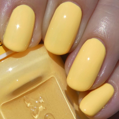 Close-up honey nail polish color with golden undertones and smooth application