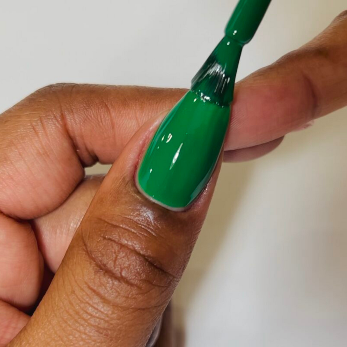 glossy jade green nails swatched on deep skin tone