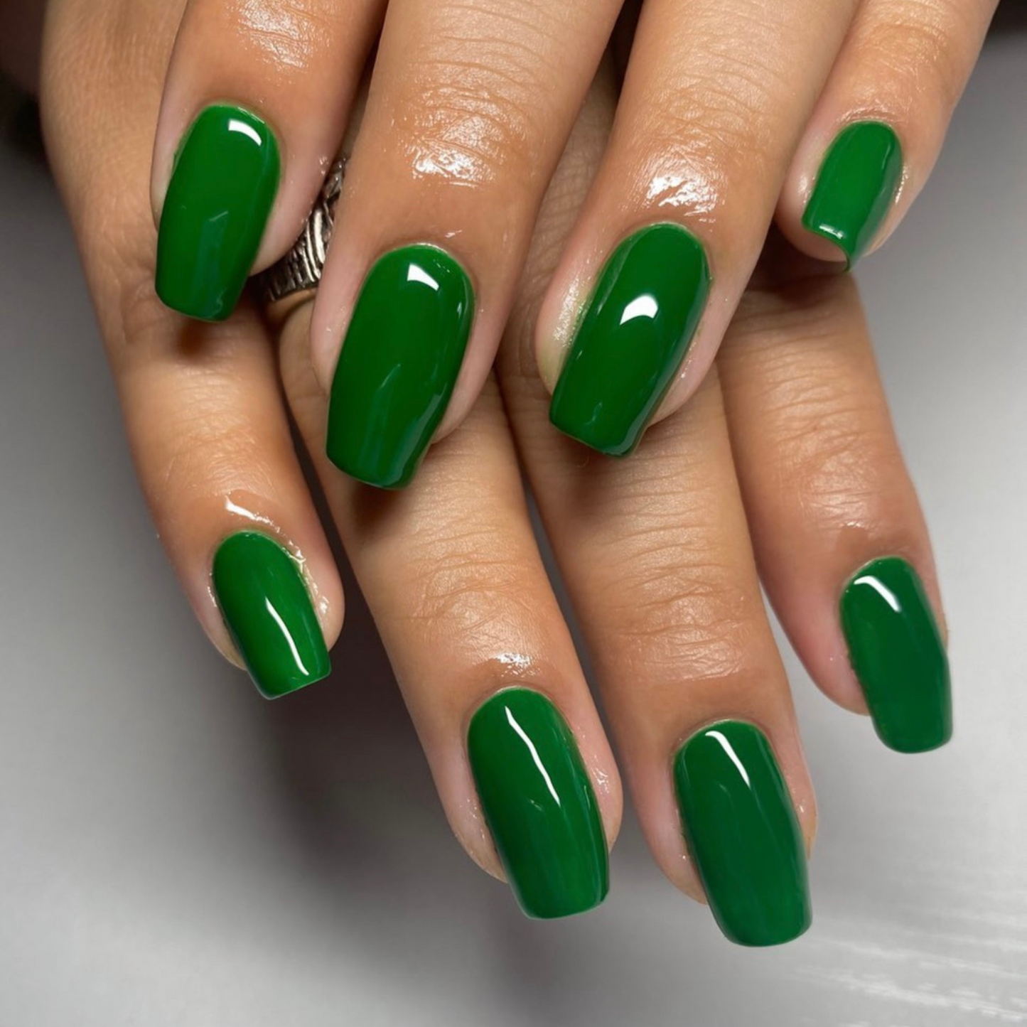 Jade green nail polish with rich pigment and smooth glossy application