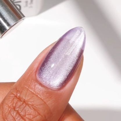 Finger with medium almond nails wearing R U Kitten Me muted pastel purple cat eye nail polish