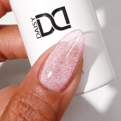Finger with medium almond nails wearing salmon paws light warm pink cat eye nail polish