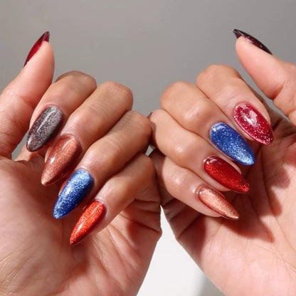 Two hands with colorful magnetic cat eye nail polish on a neutral background