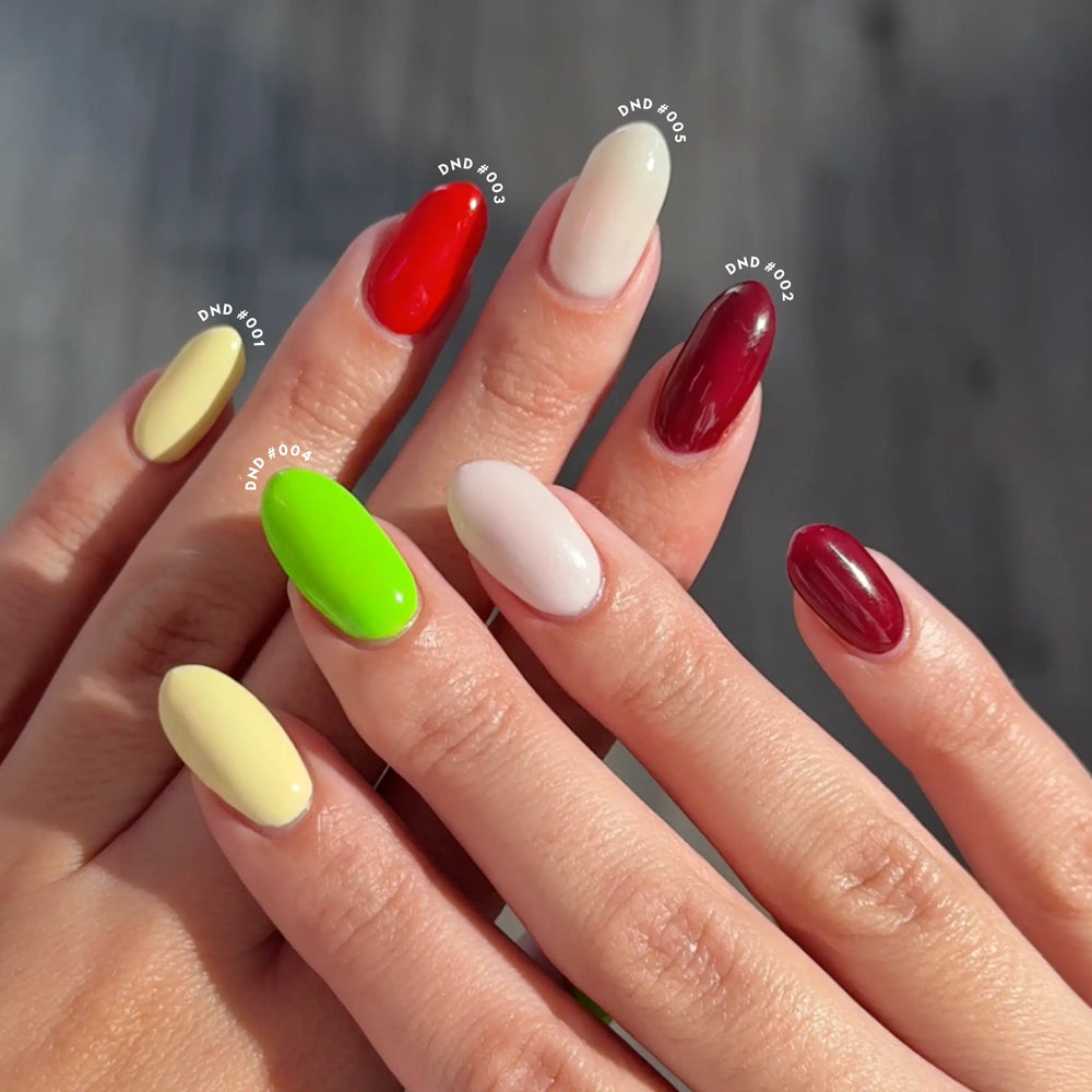 Hand with lime green, white, and maroon nail art