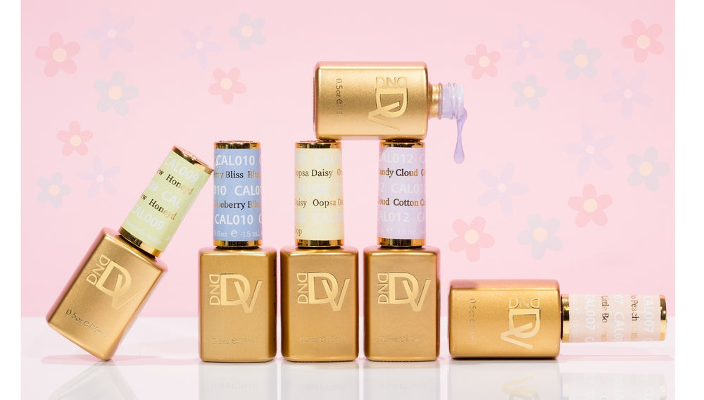 Group of tan dropper bottles and a small box on a pink floral background