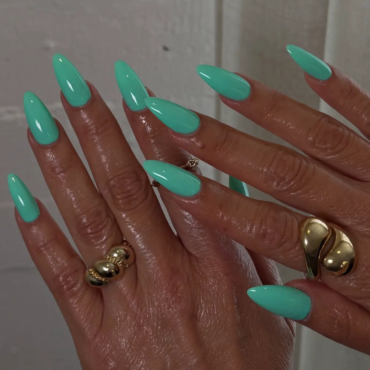 Hand with pistachio green stiletto nails, DND #668 Sweet Pistachia