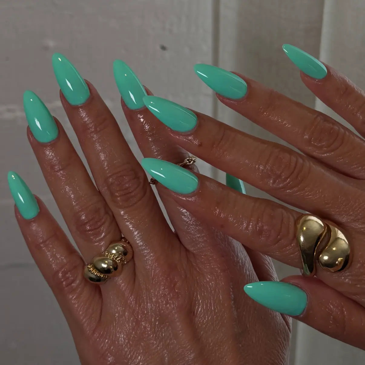 Hand with pistachio green stiletto nails, DND #668 Sweet Pistachia